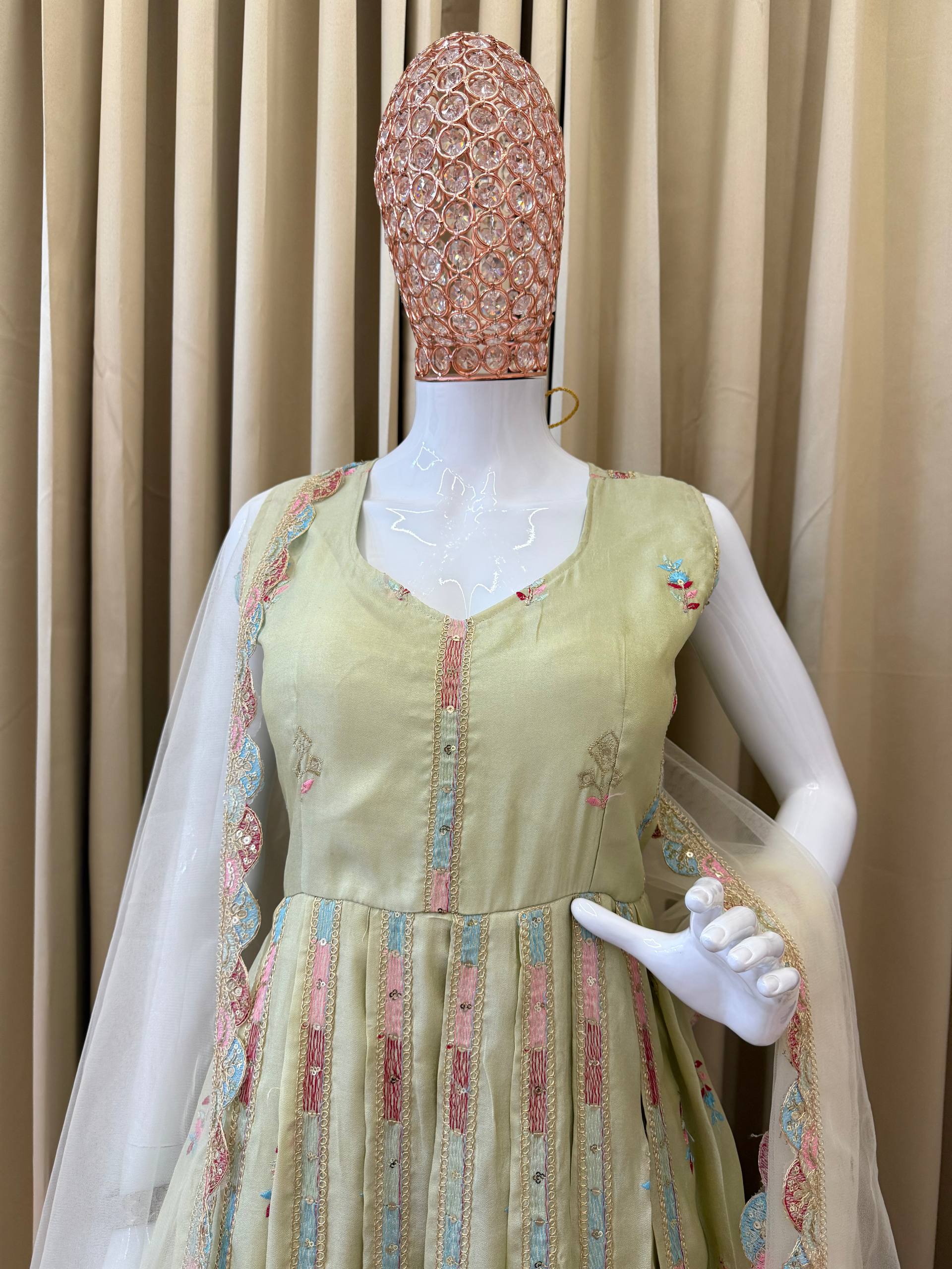 Woman in a beige, embroidered Anarkali gown.