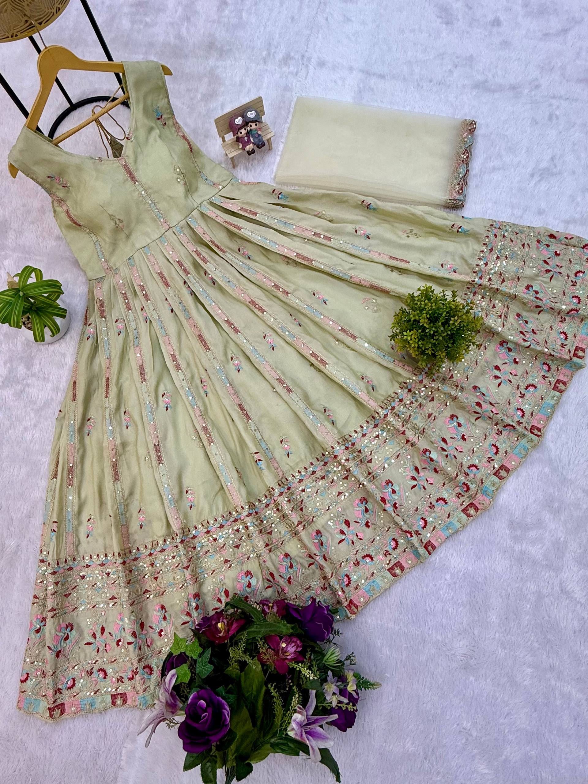 Woman in a beige, embroidered Anarkali gown.