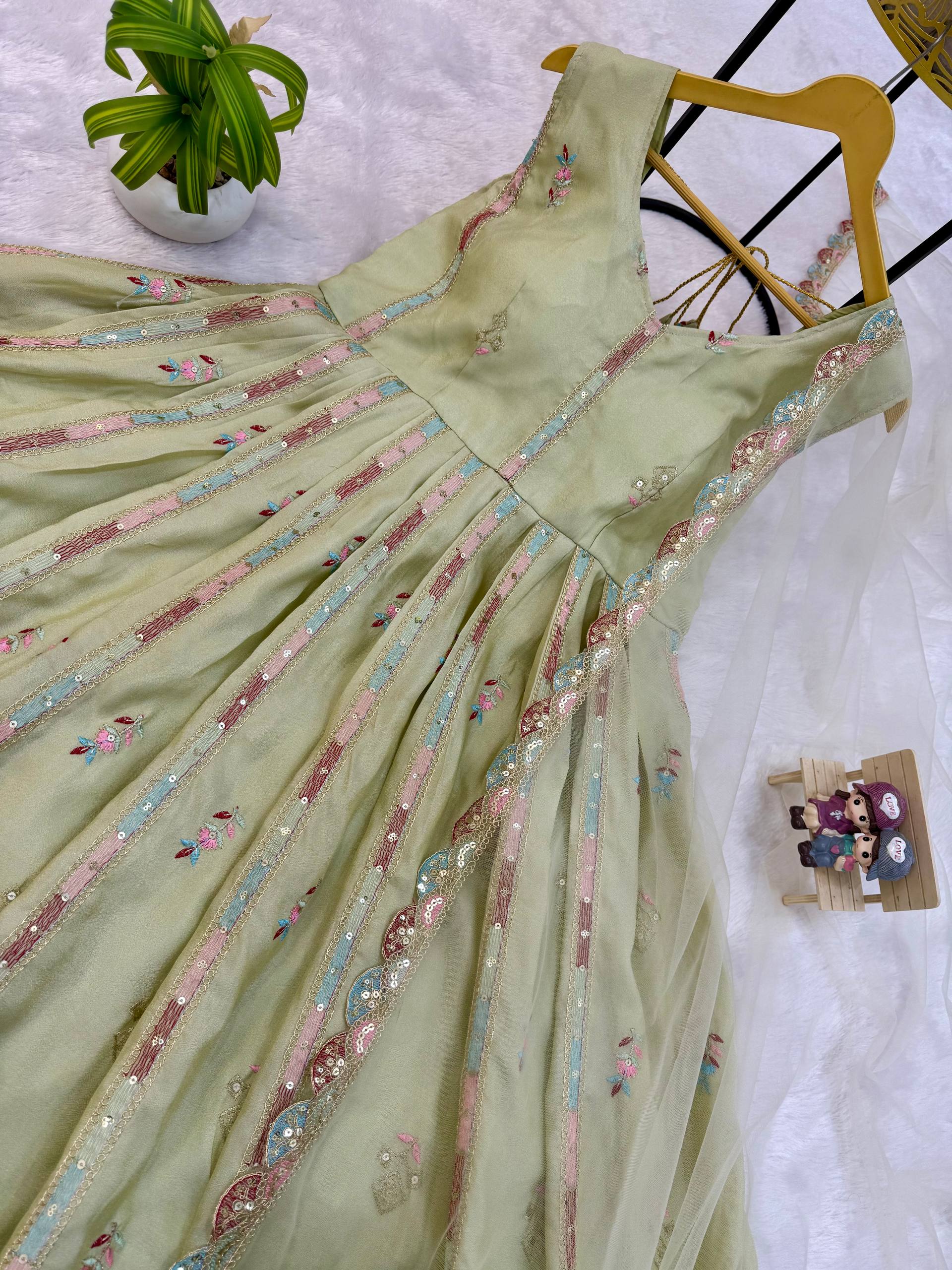 Woman in a beige, embroidered Anarkali gown.